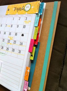 a desk calendar with sticky notes attached to it