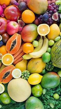 many different types of fruits and vegetables are arranged in the shape of a rainbow color scheme