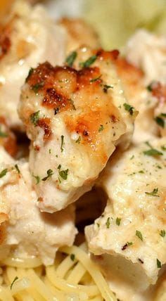 closeup of chicken and pasta with parmesan cheese on the side, ready to be eaten