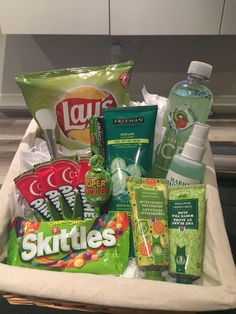 a basket filled with lots of different types of toiletries and hygiene products on top of a counter