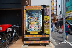 a vending machine sitting on the side of a street