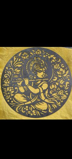 an intricately designed mat with a buddha figure on it's side in gold and black