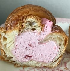 there is a pastry with pink icing on it