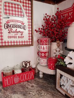 there is a red and white sign on the wall next to some coffee mugs