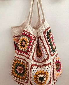 a crocheted bag hanging on the wall