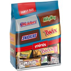 an assortment of snacks in a bag on a white background with the words milk, crackers, twix and family size