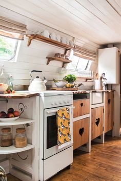 a kitchen with an oven, stove and shelves on the wall next to each other