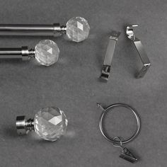 several different types of glass door knobs and handles on a gray surface with key rings