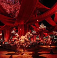 an elaborately decorated room with red drapes and chandeliers