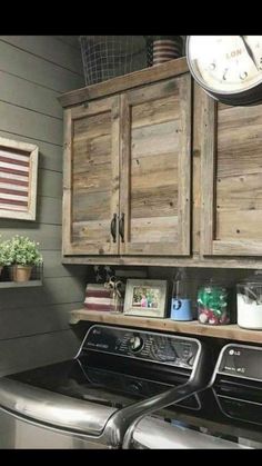 a washer and dryer in a laundry room with wooden cabinets above the washer