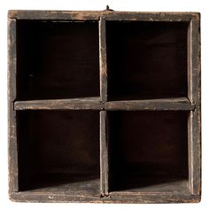 an old wooden box with four compartments