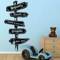 a child's room with a toy car and wall decal that says hogwarts