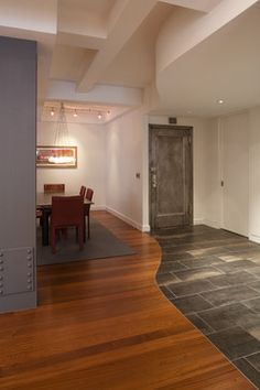 an empty room with wood floors and white walls