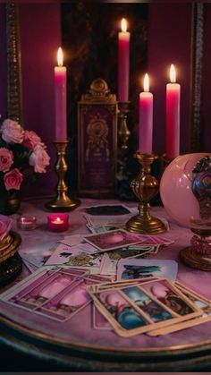 a table topped with lots of cards and candles