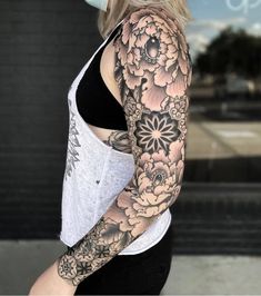 a woman with black and white flowers on her arm