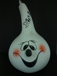 a white vase with a face painted on it