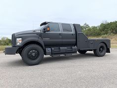 a large black truck parked in a parking lot