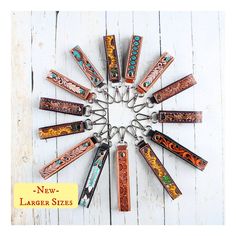 a clock made out of different types of lighters on a white wooden background with the words new larger sizes written below it