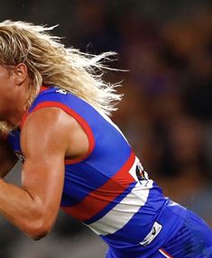 a female afl player in action on the field