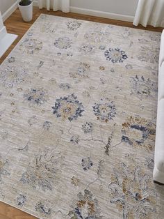 an area rug with flowers on it in a living room