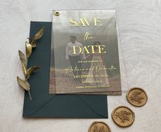 save the date card and wax stamp on top of an envelope next to some coins