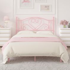 a pink bed with white sheets and pillows