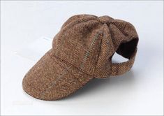 a brown hat is sitting on a white surface