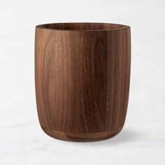 a wooden cup sitting on top of a white counter