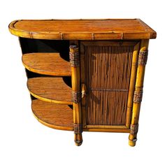 an old bamboo cabinet with drawers and wickers on the doors is isolated against a white background