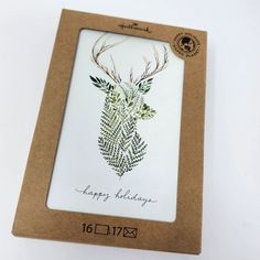 a card with an image of a deer's head on it in a cardboard box