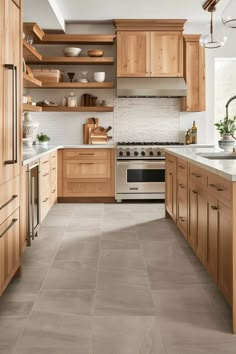 a large kitchen with wooden cabinets and white counter tops on the walls, along with an oven