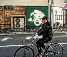 a man riding a bike down the street