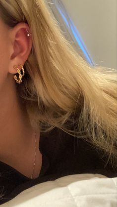 a close up of a person wearing ear rings