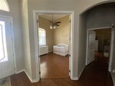 an empty living room with hard wood flooring and white trim on the walls is seen in this image