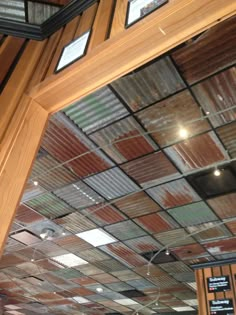 the inside of a restaurant with many different colored tin tiles on the ceiling and walls