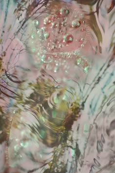 an image of water with bubbles and trees reflected in the water, as seen from above