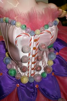 a pink and white corset with candy canes on it's chest