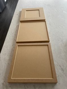 three pieces of cardboard sitting on top of a counter