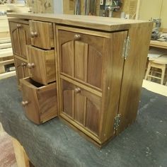 a wooden cabinet sitting on top of a table