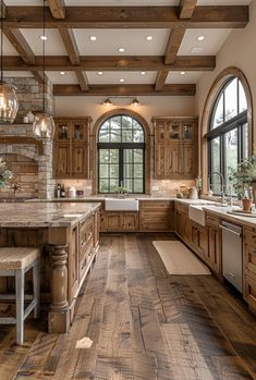 a large kitchen with wood floors and wooden cabinets