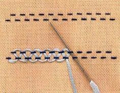 a close up of a piece of cloth with scissors and thread on the side that is stitched together