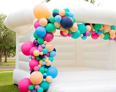 an inflatable arch decorated with balloons and streamers