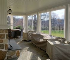 a covered patio area with couches and tables