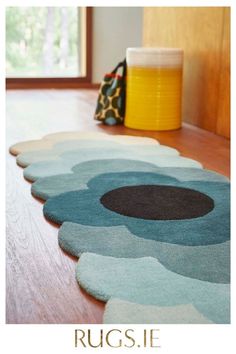 rugs are on the floor in front of a window