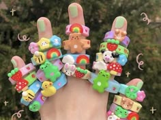 a hand with many different types of hair clips on it's fingers and the words hello kitty written above them