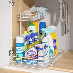 a kitchen cabinet filled with cleaning products