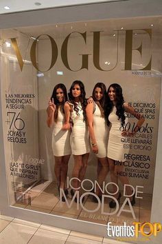 three beautiful women standing in front of a display window with the words'cosmo de moda '