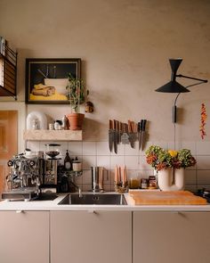 a kitchen counter with pots and pans on top of it, next to a sink