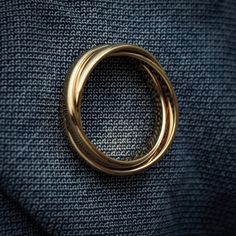 a gold ring sitting on top of a blue cloth