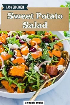 a salad with sweet potato and feta cheese in a white bowl on a marble table